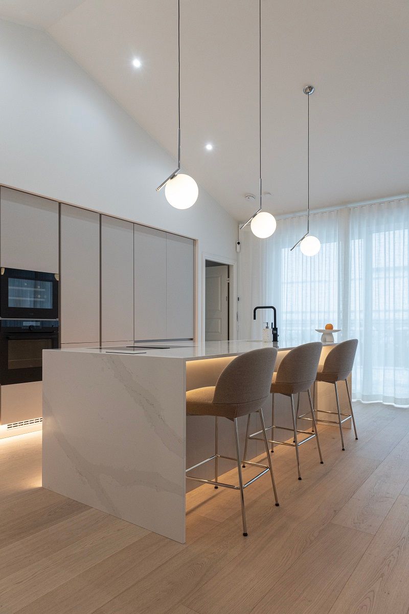 Skirting lights add atmosphere. Pendant and spot lights illuminate the kitchen.